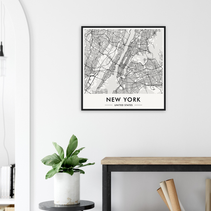 Framed map of New York City displayed on a white wall.